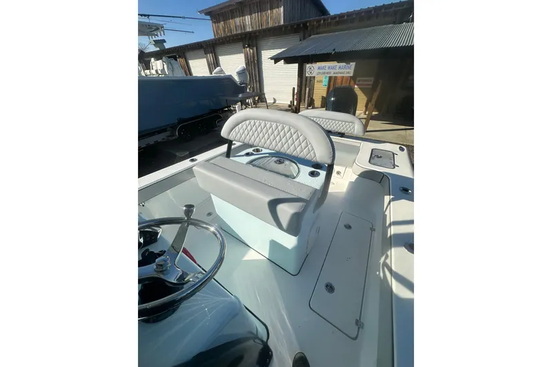 Slide: The Image of 2026 Delta Boatworks Delta D245 interior with steering wheel and cushioned seating. - 39