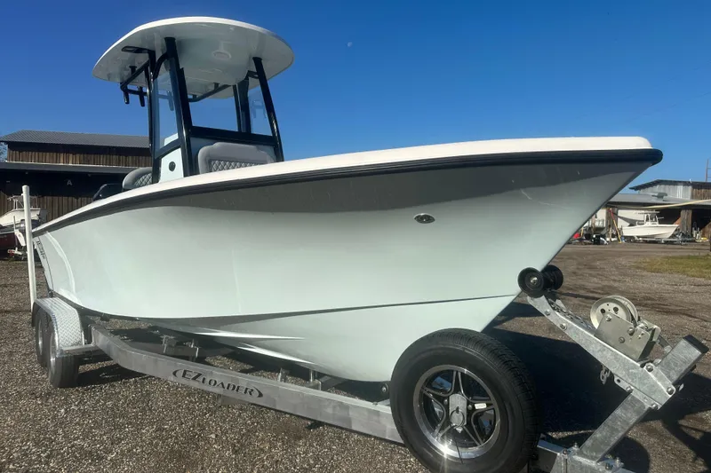Slide: The Image of 2026 Delta Boatworks Delta D245 on trailer, displayed outdoors under clear blue sky. - 5