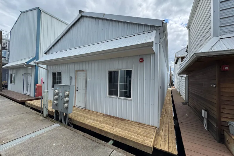 Slide: The Image of Metallic boat house with wooden deck, Larson Boat House 60', 2005 model. - 3