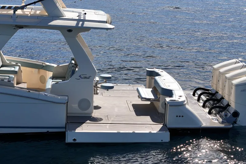 Slide: The Image of 2023 Scout 530 LXF luxury boat with spacious deck and powerful engines on water. - 19