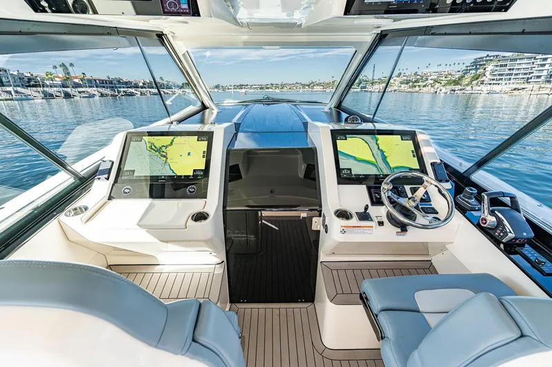 Slide: The Image of 2023 Scout 530 LXF boat cockpit with dual navigation screens and luxurious seating. - 2