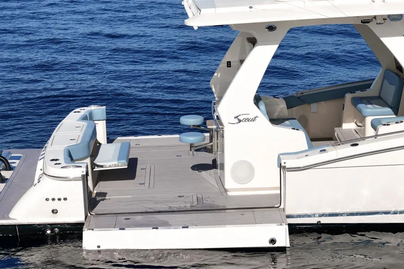 Slide: The Image of 2023 Scout 530 LXF luxury boat with spacious deck and seating on the water. - 20