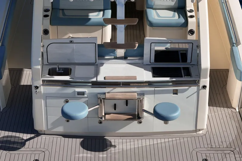 Slide: The Image of 2023 Scout 530 LXF boat interior with seating, sink, and storage. - 24