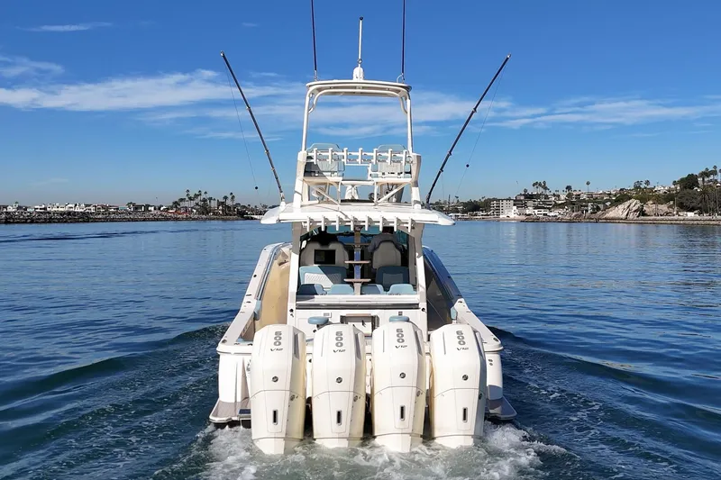 Slide: The Image of 2023 Scout 530 LXF luxury boat cruising on calm waters. - 26