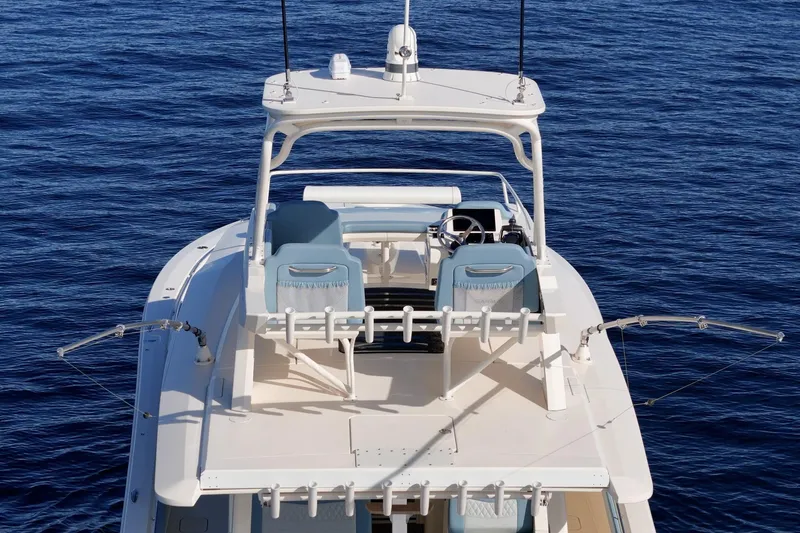 Slide: The Image of 2023 Scout 530 LXF boat on open water, showcasing upper deck and seating. - 33