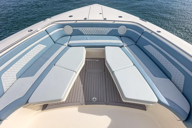 Slide: The Image of Luxurious seating area on 2023 Scout 530 LXF boat, featuring elegant blue and white upholstery. - 35
