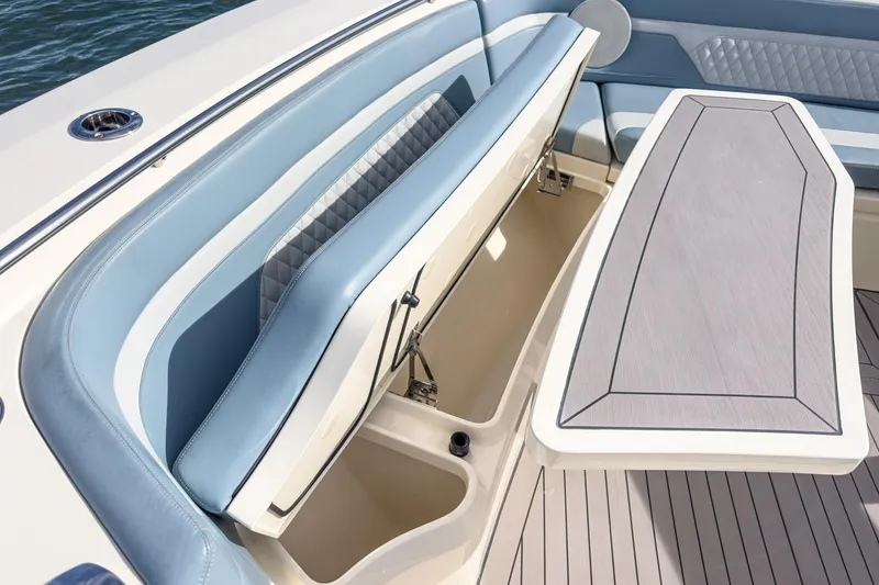 Slide: The Image of 2023 Scout 530 LXF boat interior with blue seating and storage compartment. - 36