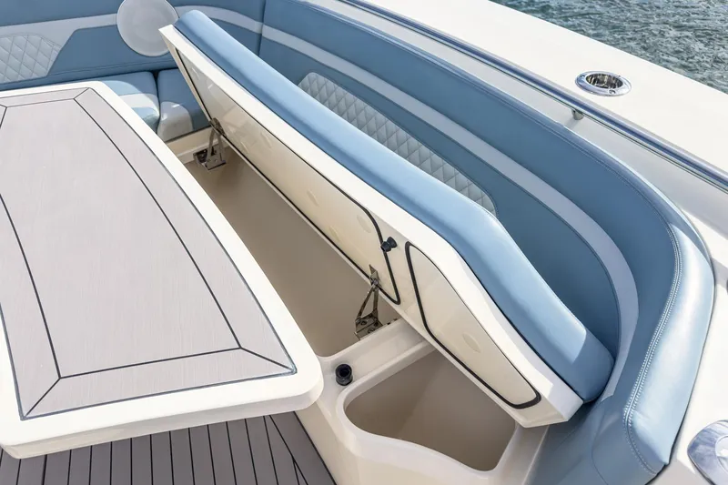 Slide: The Image of 2023 Scout 530 LXF boat interior with blue seating and storage compartments. - 37