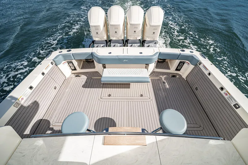 Slide: The Image of 2023 Scout 530 LXF boat deck with four engines, spacious seating, and sleek design. - 39