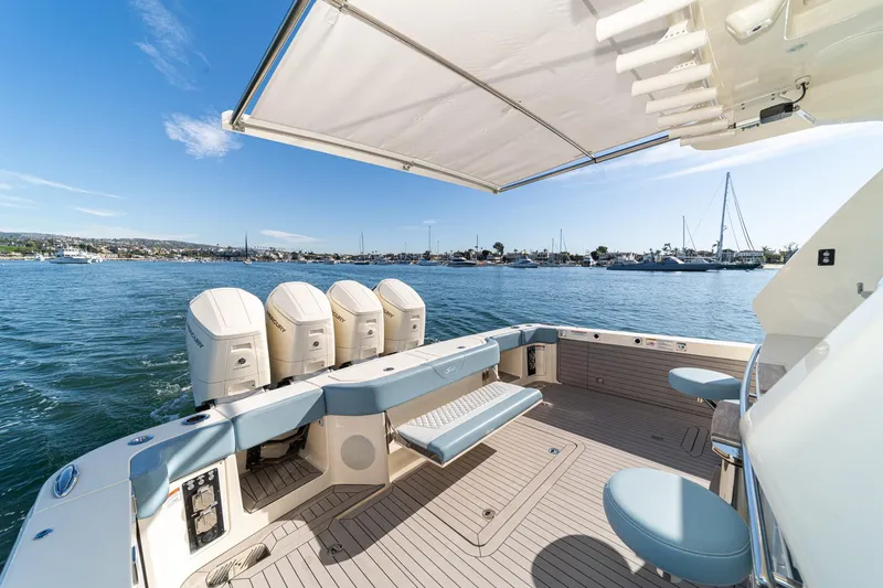 Slide: The Image of 2023 Scout 530 LXF boat deck with seating, canopy, and ocean view. - 4