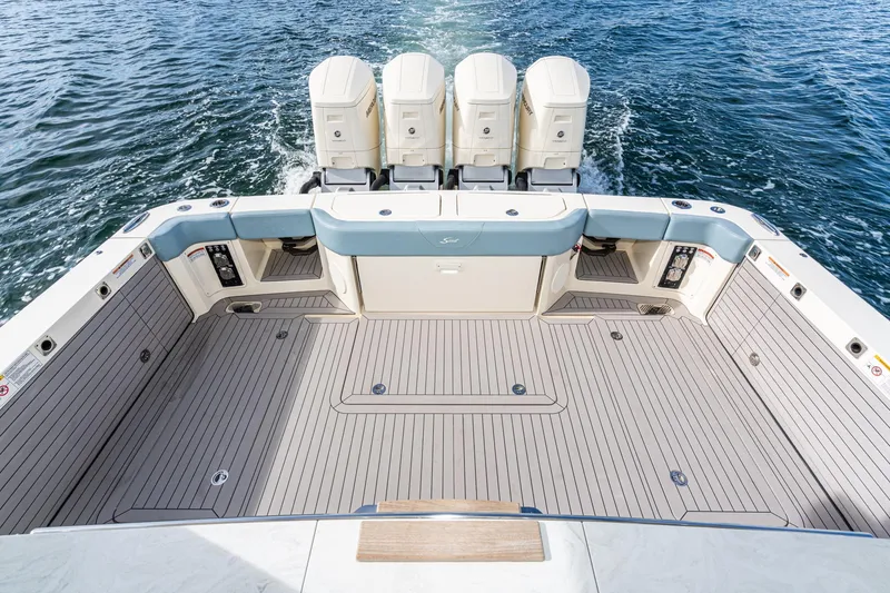 Slide: The Image of 2023 Scout 530 LXF boat deck with four outboard engines on water. - 42