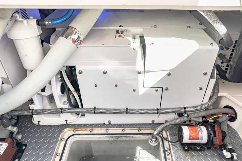 Slide: The Image of Engine compartment of 2023 Scout 530 LXF boat, showcasing mechanical components and wiring. - 44