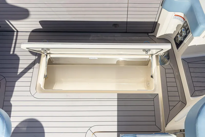 Slide: The Image of 2023 Scout 530 LXF boat storage compartment with open lid, showcasing spacious interior. - 46