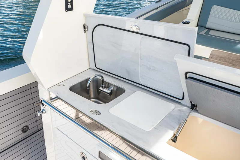Slide: The Image of 2023 Scout 530 LXF yacht featuring a sleek outdoor sink and countertop area. - 48