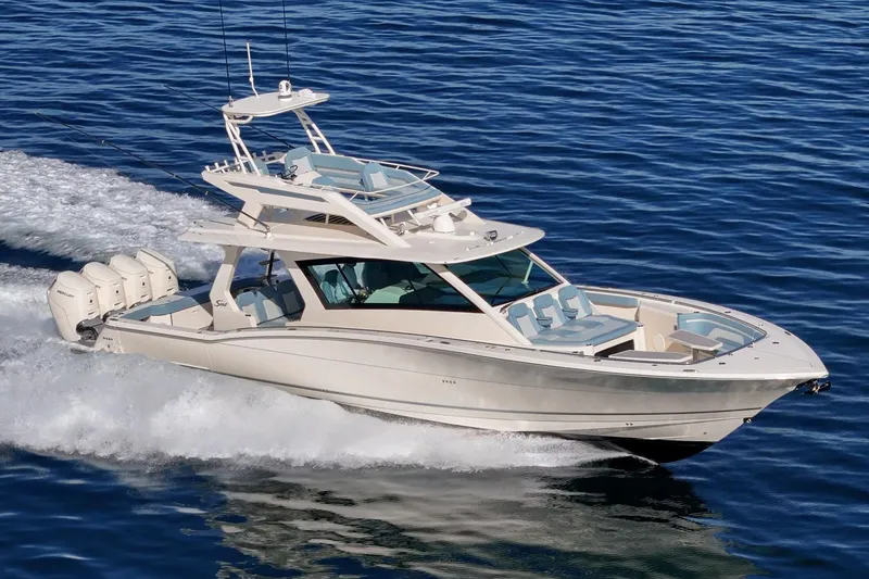 Slide: The Image of 2023 Scout 530 LXF luxury boat cruising on open water. - 5