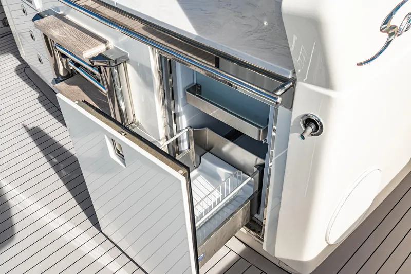 Slide: The Image of 2023 Scout 530 LXF yacht with open storage compartments on deck. - 50