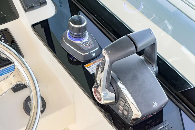 Slide: The Image of Control panel of 2023 Scout 530 LXF boat with steering wheel and throttle. - 57