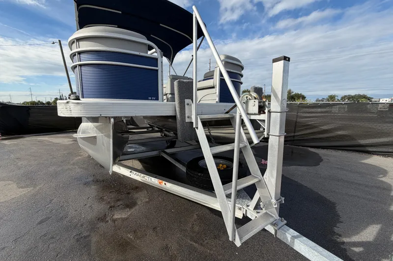 Slide: The Image of 2021 Bennington 20 SV pontoon boat on trailer under blue sky. - 10