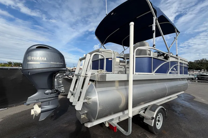 Slide: The Image of 2021 Bennington 20 SV pontoon boat with Yamaha outboard motor on trailer. - 2