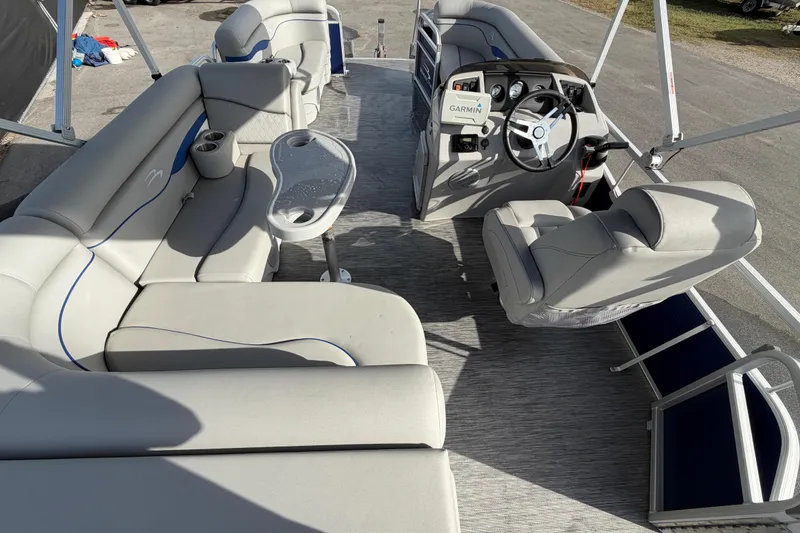 Slide: The Image of 2021 Bennington 20 SV pontoon boat interior with plush seating and steering console. - 21