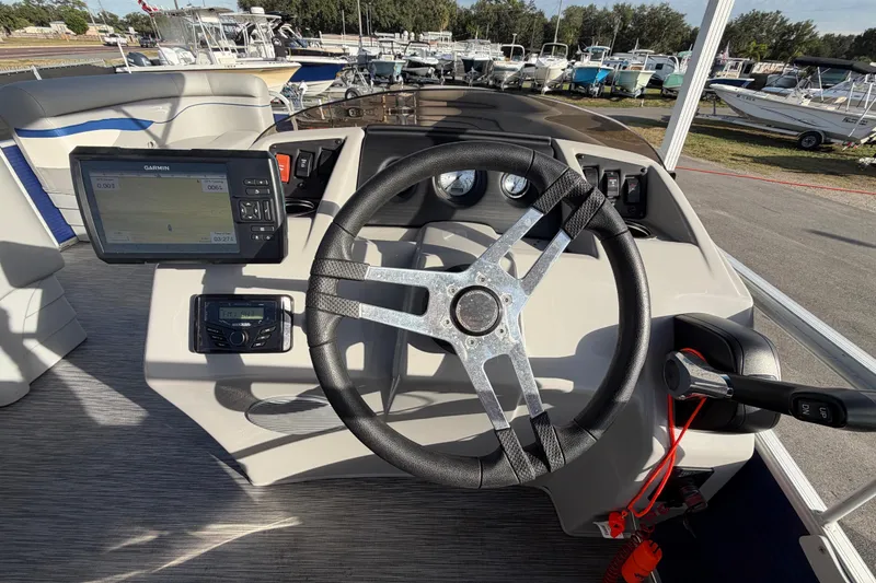 Slide: The Image of 2021 Bennington 20 SV boat dashboard with steering wheel and Garmin navigation system. - 24