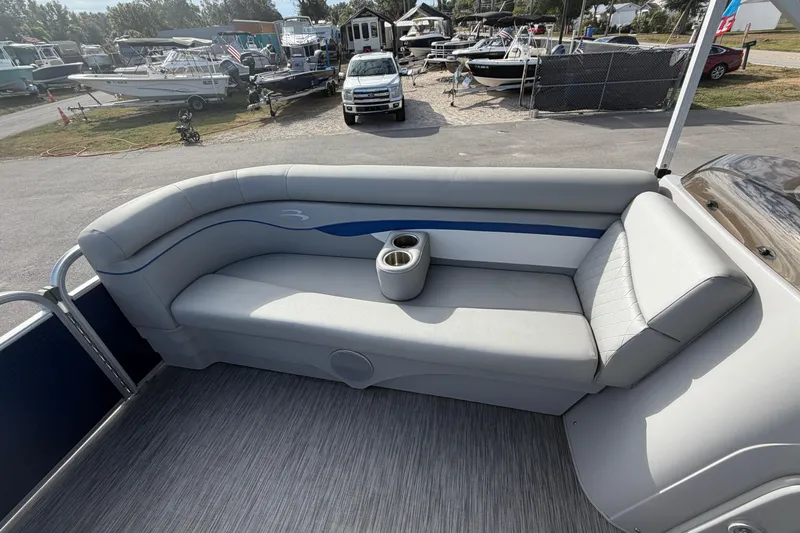 Slide: The Image of 2021 Bennington 20 SV pontoon boat interior with gray seating and cup holders. - 35