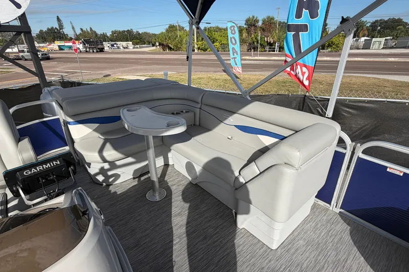 Slide: The Image of 2021 Bennington 20 SV pontoon boat interior with seating and table, featuring Garmin equipment. - 44