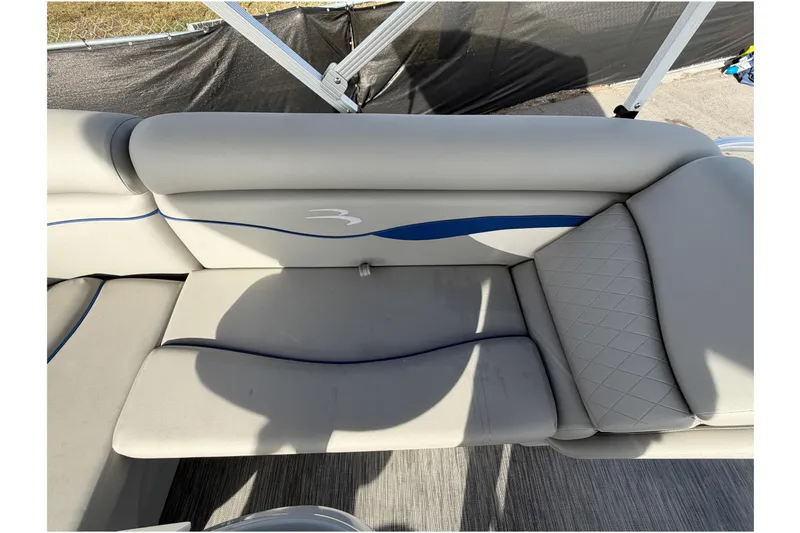 Slide: The Image of 2021 Bennington 20 SV boat interior with gray cushioned seating and blue accents. - 48