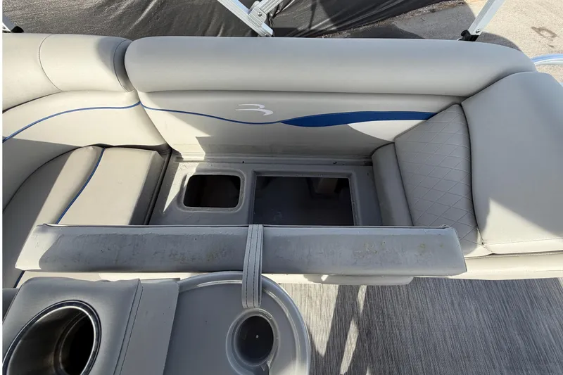 Slide: The Image of 2021 Bennington 20 SV boat interior with storage compartments and cup holders. - 49