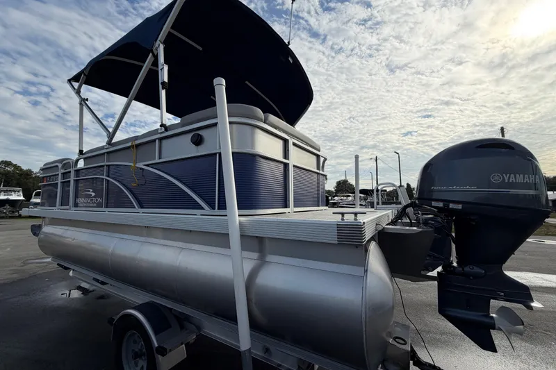 Slide: The Image of 2021 Bennington 20 SV pontoon boat with Yamaha motor, parked on a trailer. - 7