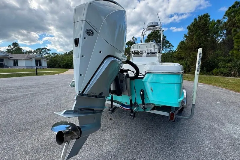Slide: The Image of 2021 BlackJack 256 Coastal boat with powerful outboard motor on a trailer. - 14