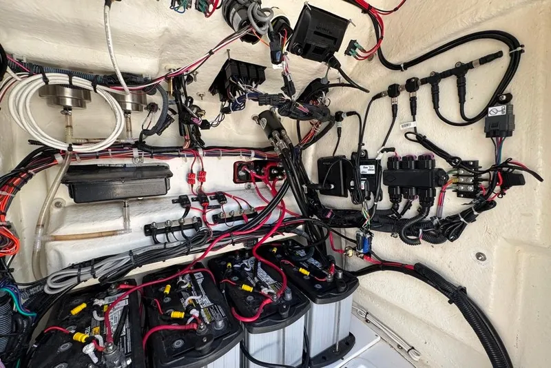 Slide: The Image of Electrical wiring and battery setup in a 2021 BlackJack 256 Coastal boat. - 16