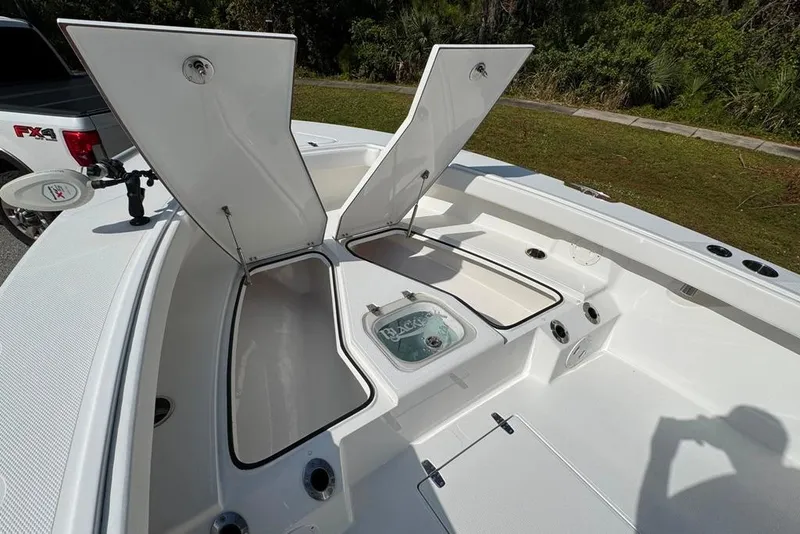 Slide: The Image of 2021 BlackJack 256 Coastal boat with open storage compartments and livewell. - 19