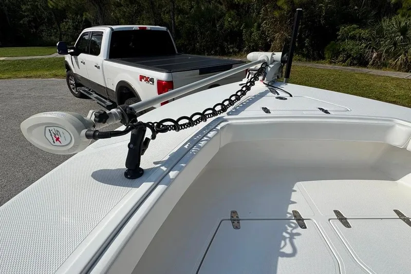 Slide: The Image of 2021 BlackJack 256 Coastal boat with a white pickup truck in the background. - 21