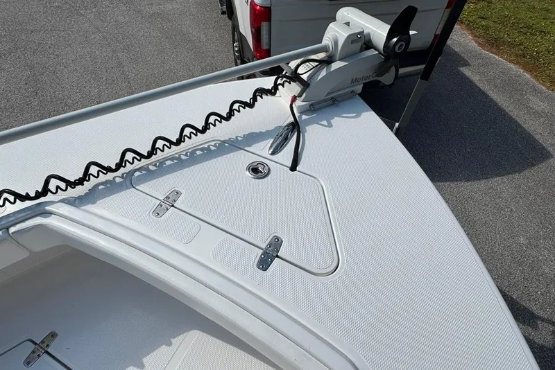 Slide: The Image of 2021 BlackJack 256 Coastal boat deck with trolling motor, parked on pavement. - 22