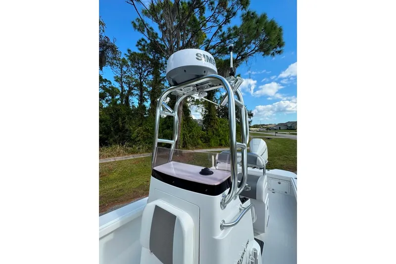 Slide: The Image of 2021 BlackJack 256 Coastal boat console with radar, set against a scenic outdoor backdrop. - 25