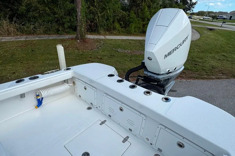 Slide: The Image of 2021 BlackJack 256 Coastal boat with Mercury engine, featuring spacious deck and storage compartments. - 29