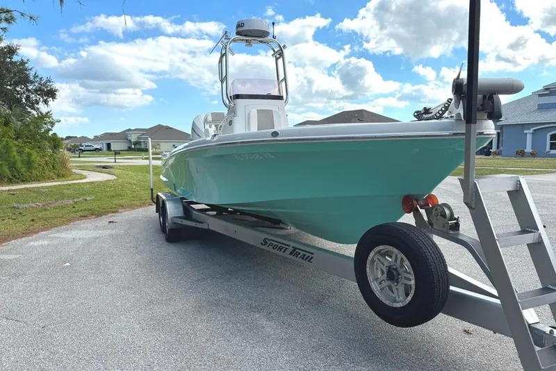 Slide: The Image of 2021 BlackJack 256 Coastal boat on trailer, parked outdoors under a cloudy sky. - 3