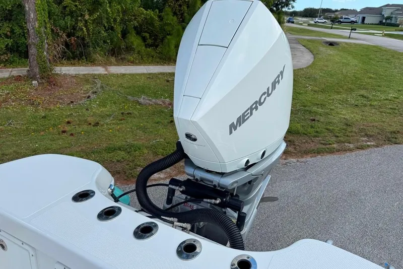 Slide: The Image of 2021 BlackJack 256 Coastal boat with Mercury outboard motor, parked on grass. - 33