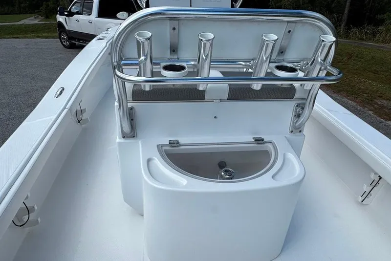 Slide: The Image of 2021 BlackJack 256 Coastal boat interior with rod holders and storage compartment. - 34