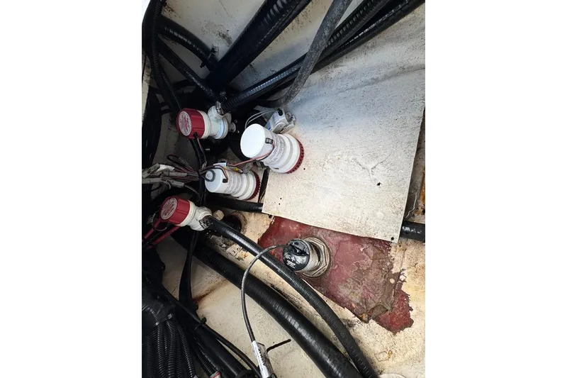 Slide: The Image of 2021 BlackJack 256 Coastal boat wiring and plumbing components in engine compartment. - 37