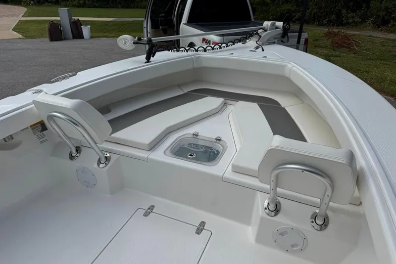 Slide: The Image of 2021 BlackJack 256 Coastal boat interior with cushioned seating and storage compartments. - 39