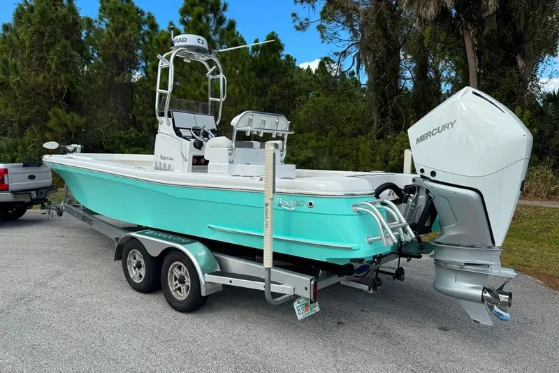 Slide: The Image of 2021 BlackJack 256 Coastal boat on trailer, featuring a Mercury outboard motor. - 5