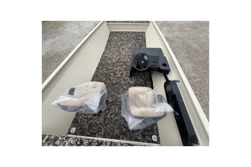 Slide: The Image of 2001 SeaArk 2272 MV boat on trailer with Yamaha motor, parked beside red truck. - 3