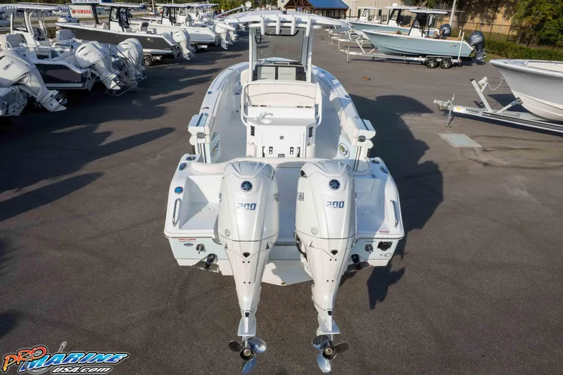 Slide: The Image of 2026 Sea Hunt Ultra 265 SE boat with dual Yamaha 200 engines in a marina. - 10