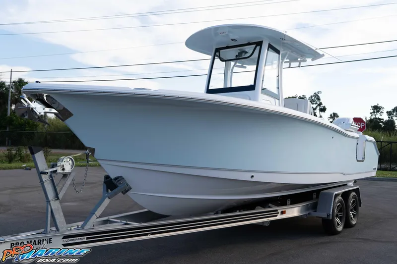 Slide: The Image of 2026 Sea Hunt Ultra 265 SE boat on trailer, parked outdoors. - 12