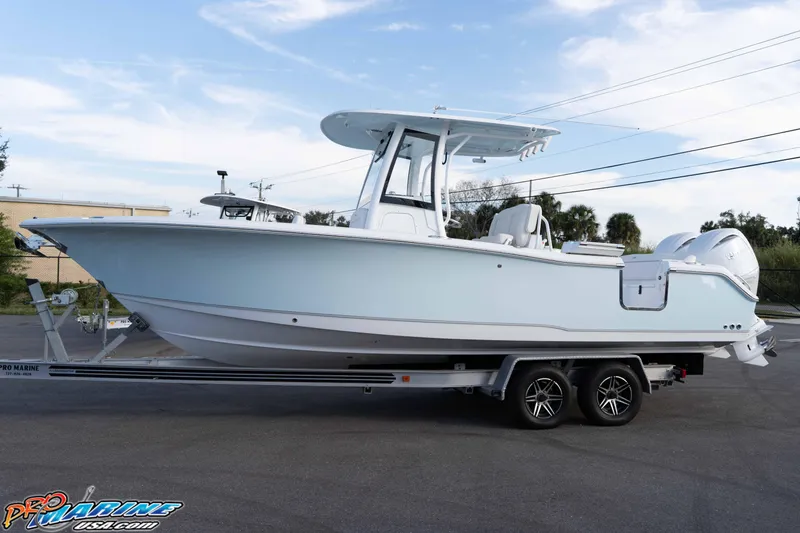 Slide: The Image of 2026 Sea Hunt Ultra 265 SE boat on trailer, side view, clear sky background. - 13