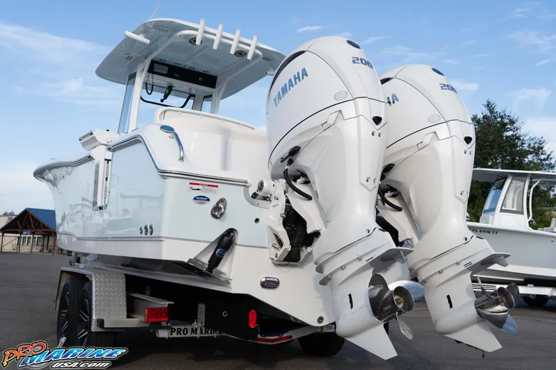Slide: The Image of 2026 Sea Hunt Ultra 265 SE boat with dual Yamaha engines on a trailer. - 14