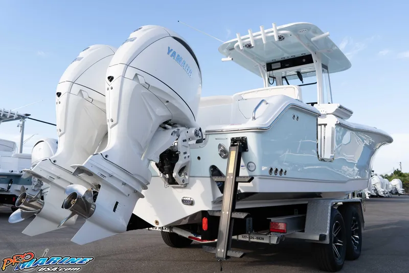 Slide: The Image of 2026 Sea Hunt Ultra 265 SE boat with dual Yamaha outboard engines on a trailer. - 17