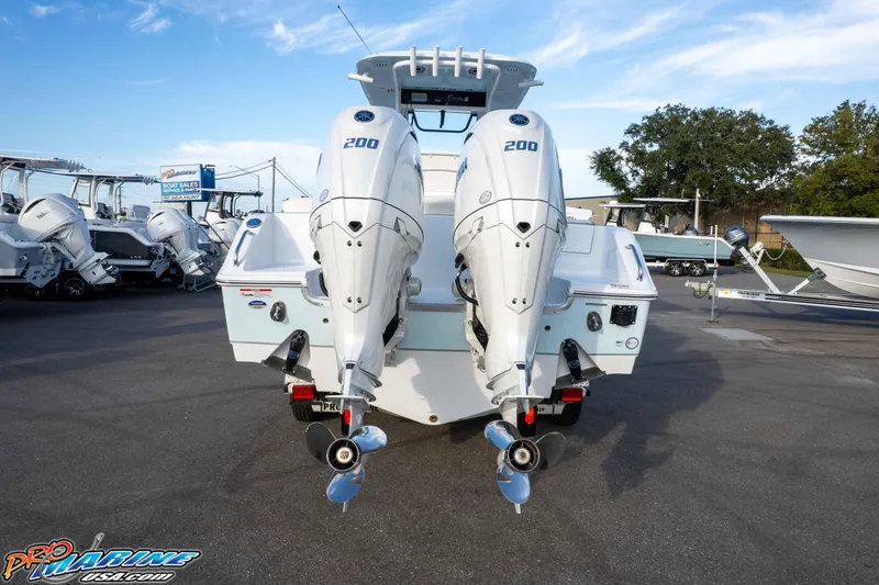 Slide: The Image of 2026 Sea Hunt Ultra 265 SE boat with dual 200 horsepower engines at dealership. - 18